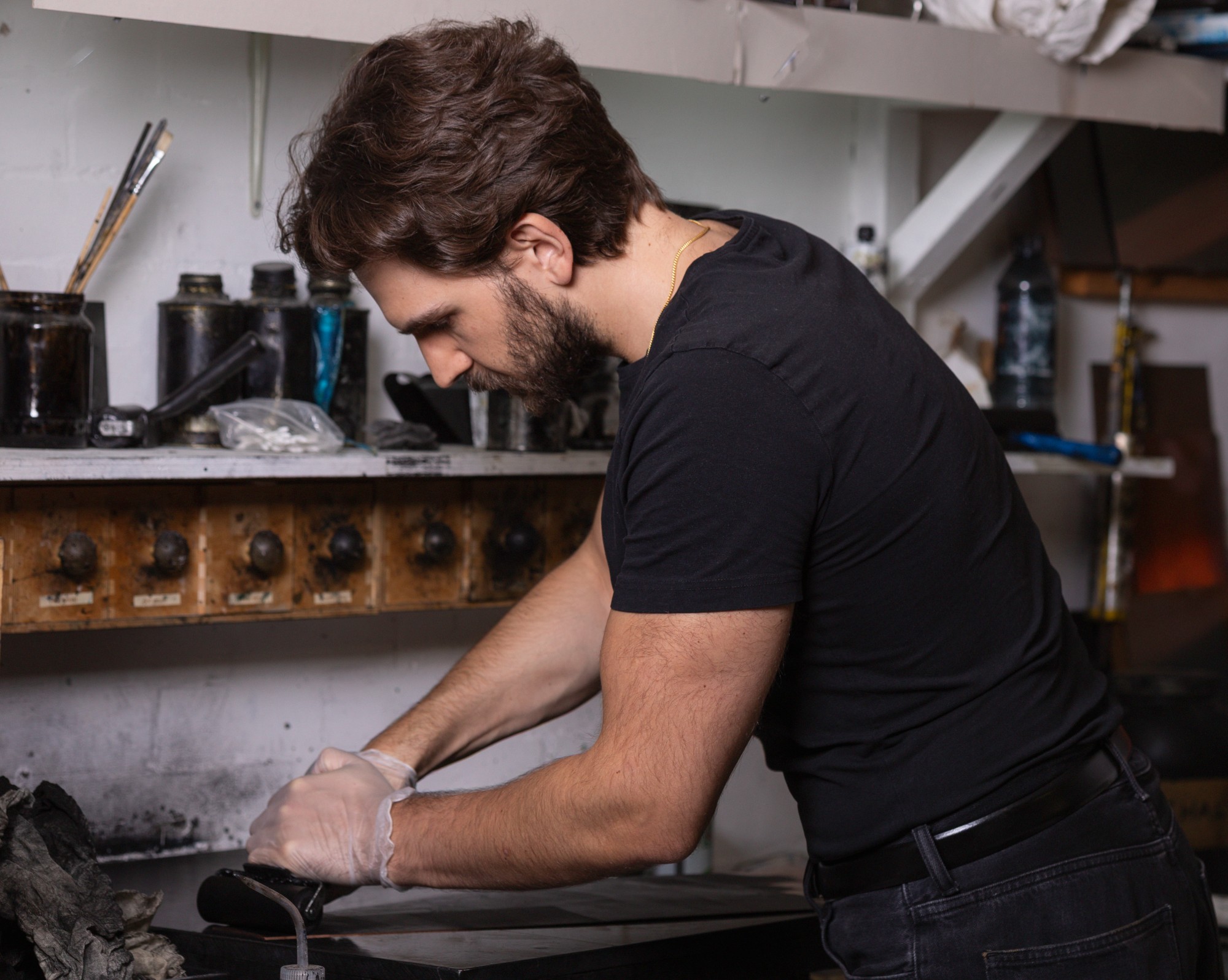 Leonardo Frigo working ink into an engraved copper plate by hand