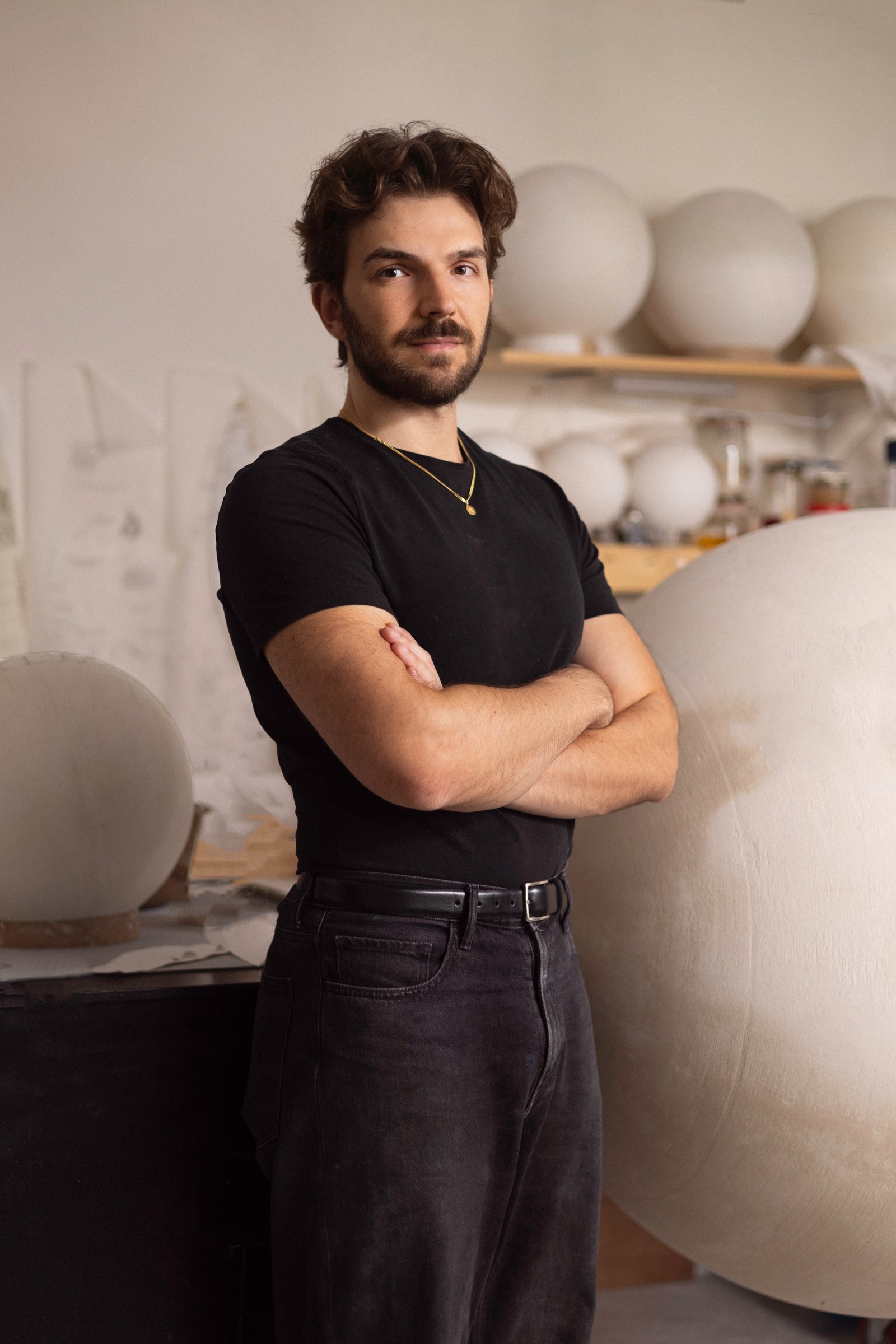 Portrait of Leonardo Frigo in his studio, plaster spheres on the shelf behind him